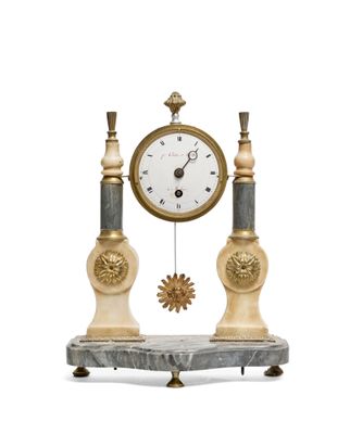 a clock that is sitting on top of a marble stand