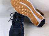 the sole of a pair of black and white sneakers on a white surface