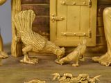 a gold statue of a woman and birds in front of a door