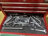 a red tool box filled with wrenches and other tools