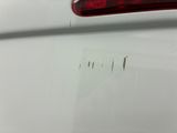 a close up of a car ' s tail light with a lot of scratches on it
