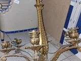 a gold candle holder and a mirror on the floor