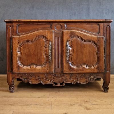 a wooden cabinet with two doors on the top of it
