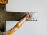 a close up of a metal cross with a wooden cross on it