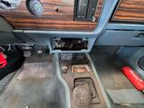 the interior of a car with a wooden dash panel and dashboard controls