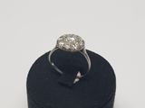 a close up of a diamond ring on a black ring holder