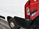 a white van that is parked on the side of the street