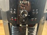 a close up of a coffee maker on a wooden table