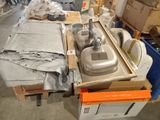 a table with a sink and some boxes in the background