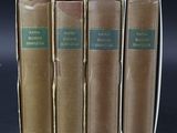 three old books sitting on top of each other on a table