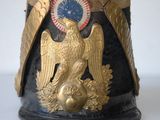 a black and gold helmet with a gold eagle on it