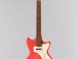 an electric guitar hanging from a string on a wall