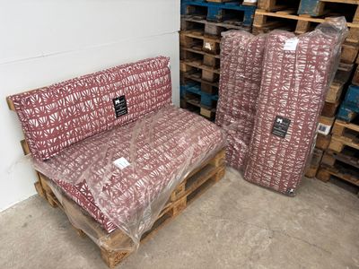 many pallets of furniture that are in a warehouse
