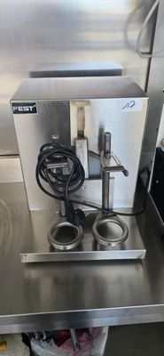 a machine that is sitting on a table in a kitchen