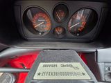 a picture of a car dashboard with gauges and speedometers