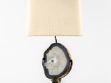 a table lamp with a white shade on top of it