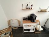 a coffee maker on a small table in a room