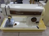 a sewing machine that is sitting on the floor