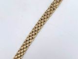 a gold bracelet with a clasp that is attached to it