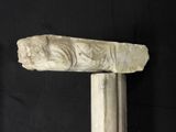 a stone carving of a lion on top of a pillar