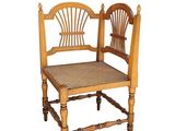 a wooden chair that has a woven seat on it