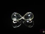 pair of clear crystal tear shaped earrings on black background