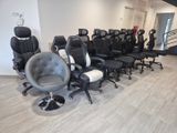 many black and white office chairs lined up in a row