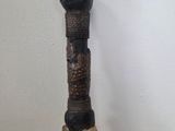 a wooden stick with a carved head on top of it