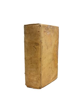 an old book sitting on top of a white surface