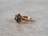 an image of a gold ring with a black diamond