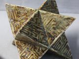 a small origami with a piece of paper attached to it