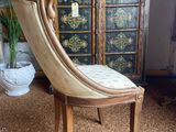 a chair that is sitting in front of a cabinet
