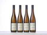 three bottles of wine sitting on top of a table next to each other