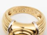 a close up of a gold ring with a stone in the middle