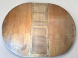 a round wooden table with two different sections of wood on it