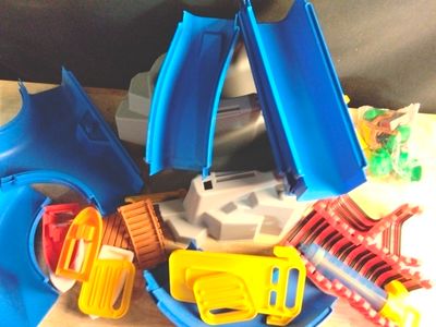 a pile of plastic toys that are on a table