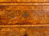 an old wooden chest of drawers with brass hardware on top of it