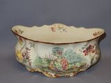 a large bowl with a painting on it sitting on a table