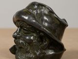 statue of a man with a hat and a beard on a table