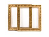 a pair of antique gold picture frames on a white background