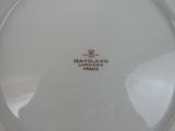 a close up of a white plate with a red and white logo
