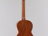 an old guitar hanging from the ceiling in a room