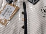 a white polo shirt with a tag on it
