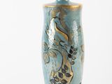 a blue vase with a gold design on it