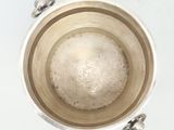 overhead view of a metal bowl filled with water on a white surface