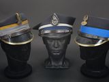 three hats are lined up on top of each other on a black surface