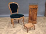 a chair that is next to a cabinet on the floor