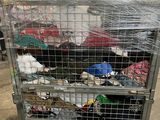 a metal cart with many items in it in a warehouse