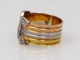 an image of a gold and silver ring on a white surface