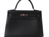 a black leather handbag on a white background